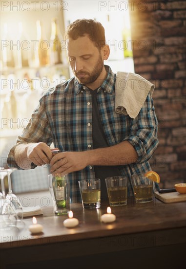 Bartender opening bottle.