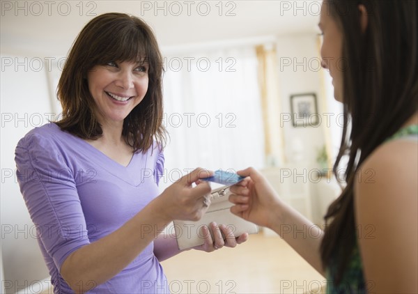 Mom giving teenage girl (14-15) credit card