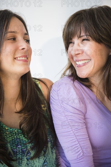 Teenage girl (14-15) and mom laughing