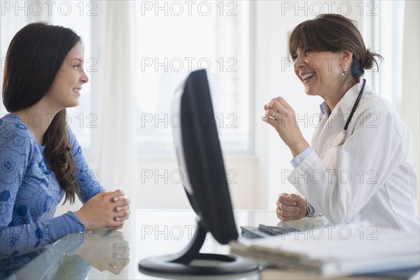 Doctor talking with teenage patient (14-15)