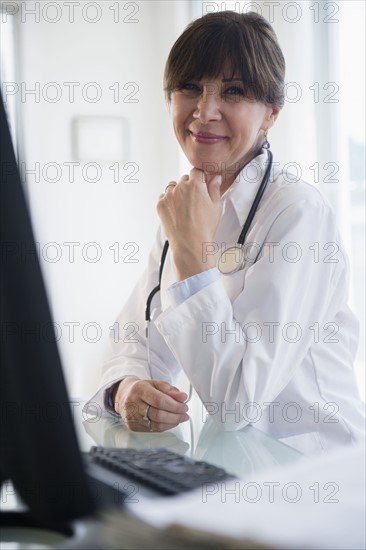 Portrait of doctor sitting at desk