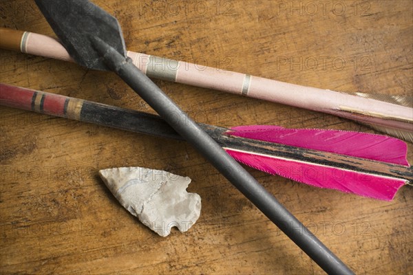 Arrows and arrowhead on table