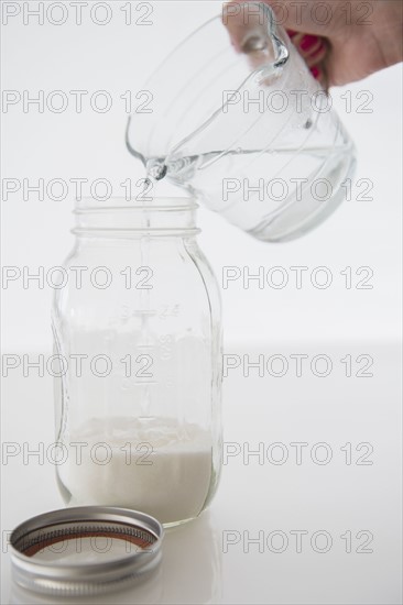 Woman mixing milk with water