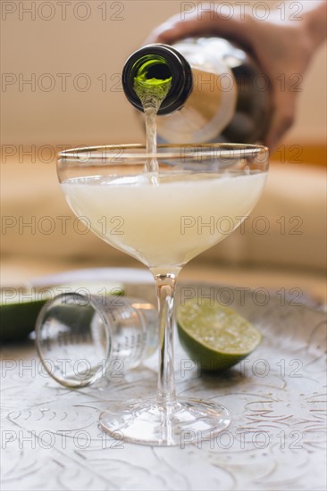 Woman mixing champagne with cocktail