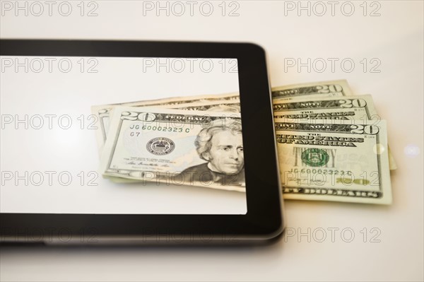 Digital tablet and twenty dollar bills