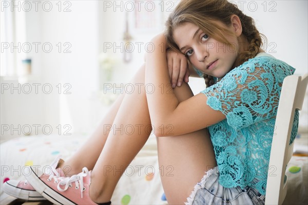 Portrait of girl (12-13) in bedroom