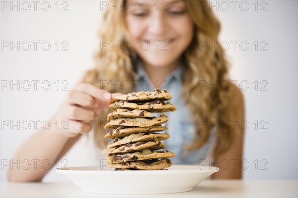 Studio shot of girl (12-13) with pancakes