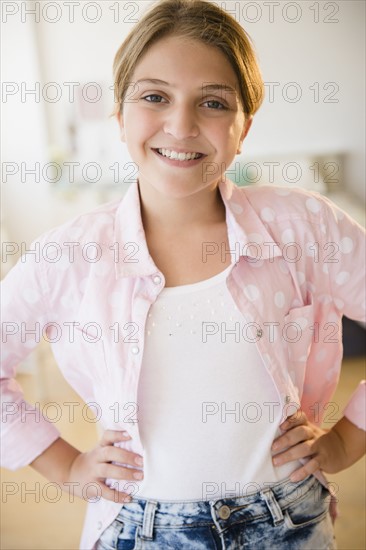 Portrait of girl (12-13) with arms akimbo