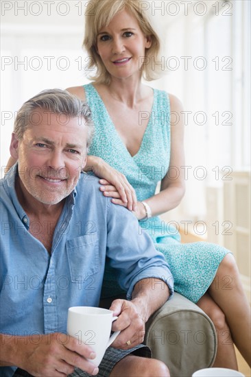 Portrait of couple sitting on sofa