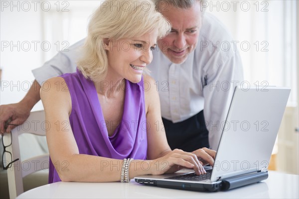 Portrait of couple looking at laptop screen