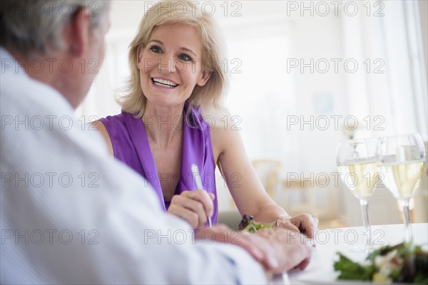Portrait of woman talking to man at restaurant table