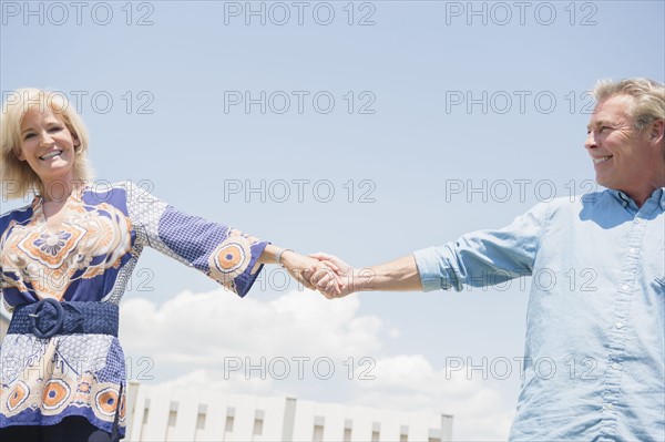 Portrait of smiling couple holding hands