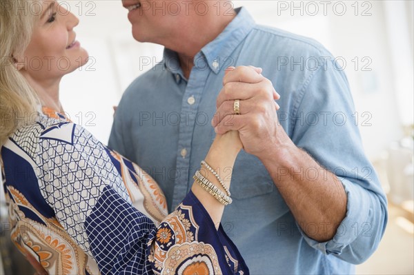 Cropped shot of husband and wife dancing