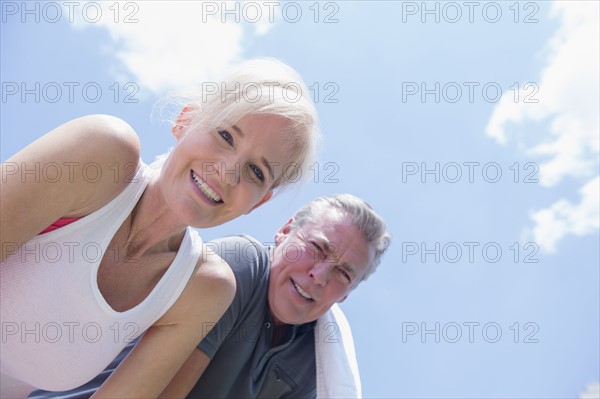 Portrait of smiling couple against sky