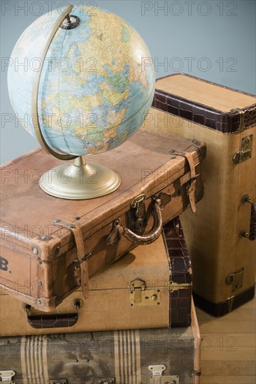 Studio shot of globe on suitcases