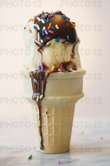 Studio shot of ice cream cone with chocolate sauce