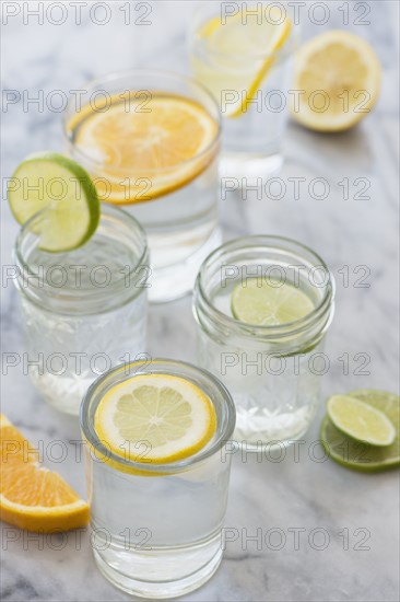 Studio shot of lemon, orange and lime drinks