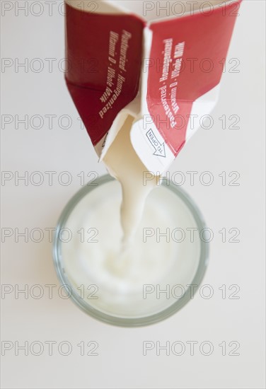 Studio shot of milk pouring into glass