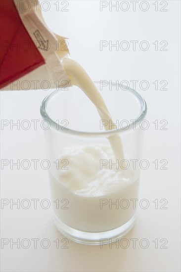 Studio shot of milk pouring into glass