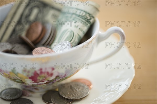 Studio shot of money in tea cup