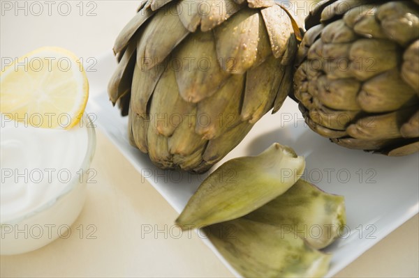 Studio shot of artichokes and dip