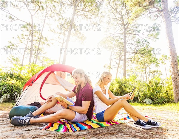 Couple sitting in front of tent