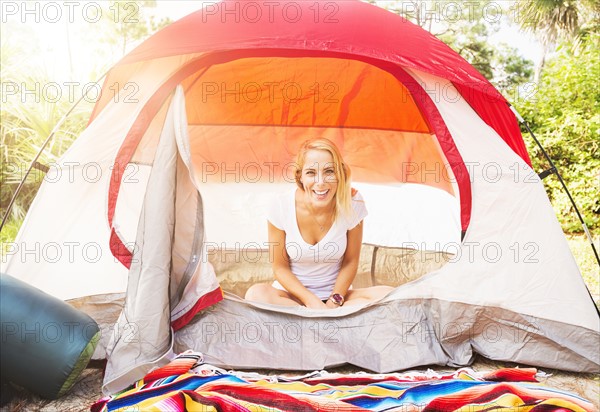 Portrait of woman sitting in tent