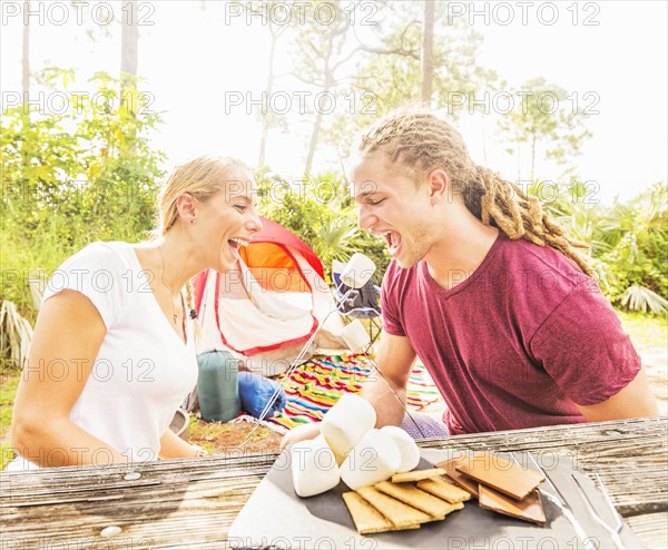 Couple sitting at table with snacks