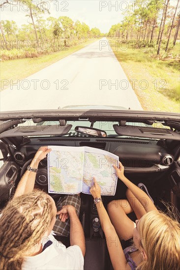 Couple checking map while driving