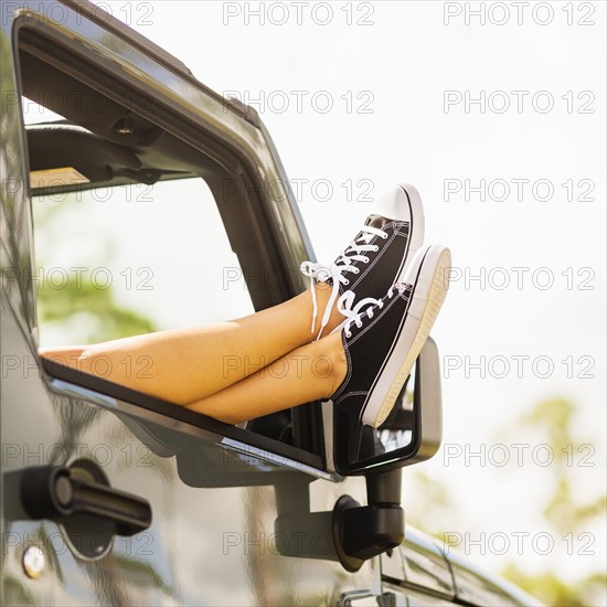 Woman keeping legs outside car