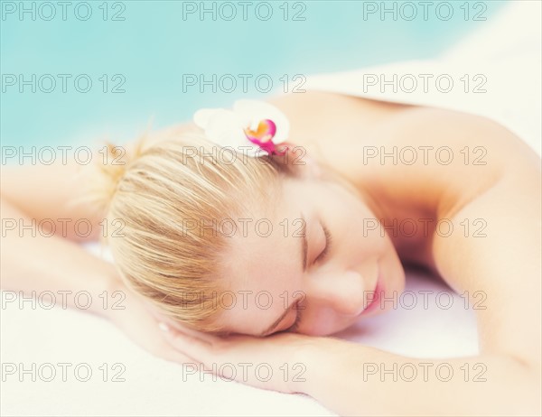Woman lying next to swimming pool