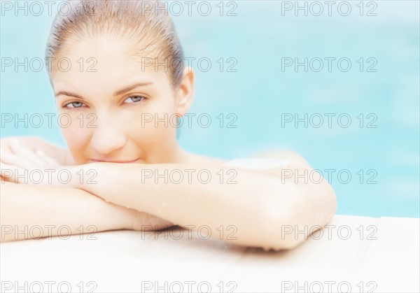 Portrait of woman on edge of swimming pool