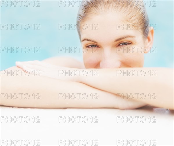 Portrait of woman on edge of swimming pool