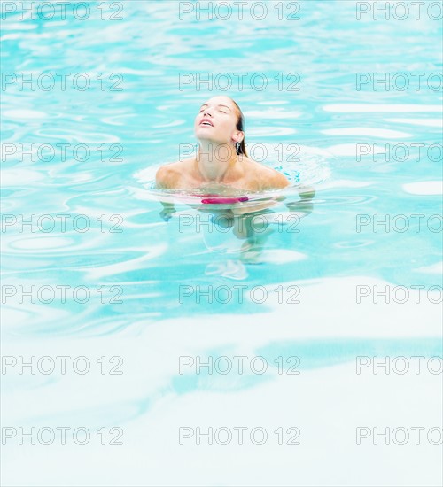 Woman swimming in swimming pool