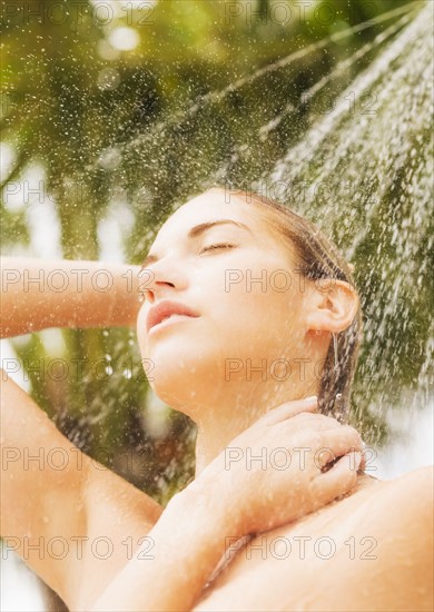 Woman taking shower outdoors