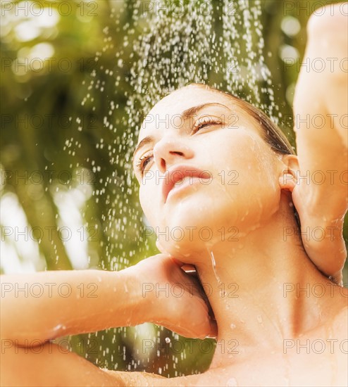 Woman taking shower outdoors