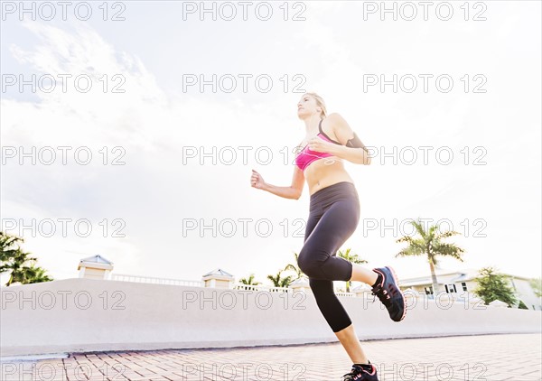 Woman running along promenade