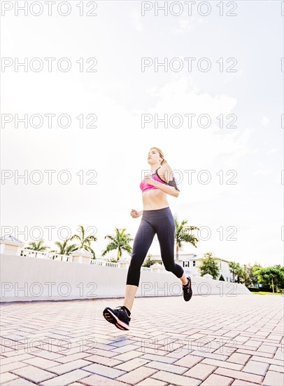 Woman running along promenade