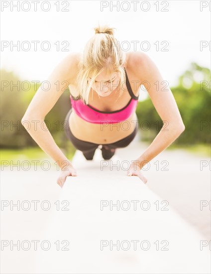 Woman doing pushups outdoors