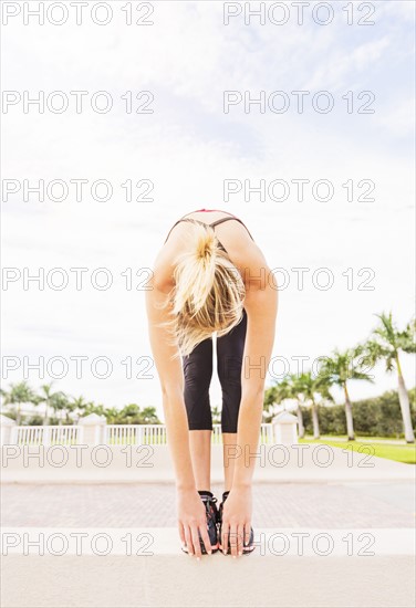 Woman reaching for toes