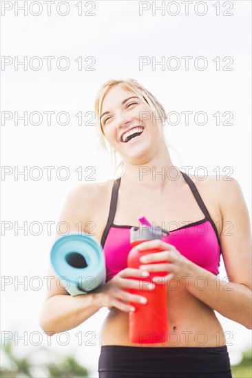 Portrait of smiling woman drinking water