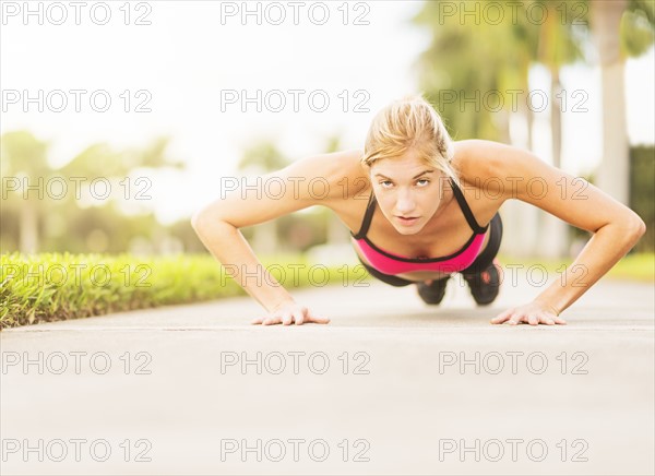 Woman doing pushups outdoors