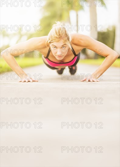 Woman doing pushups outdoors