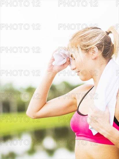 Woman whipping sweat off forehead