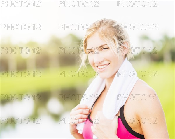 Portrait of smiling woman with towel around neck