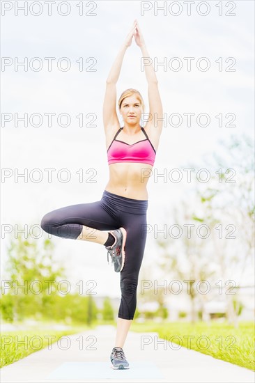 Young woman doing yoga in park