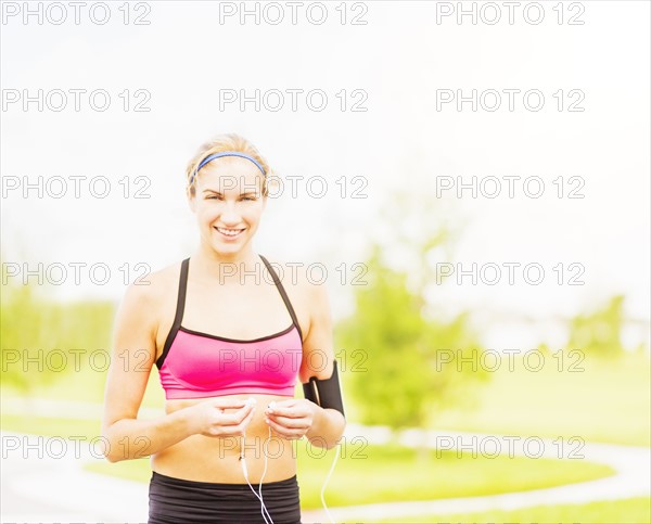Portrait of young woman in sports clothing standing in park
