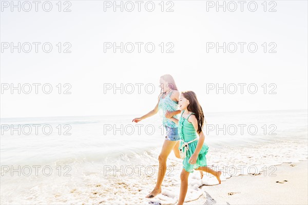 Mom and daughter (6-7) spending time together on beach