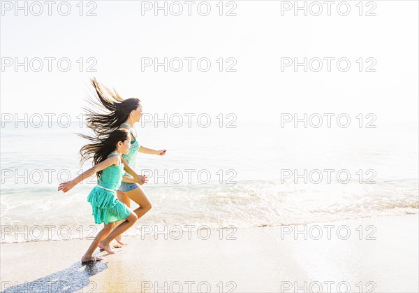 Mom and daughter (6-7) spending time together on beach