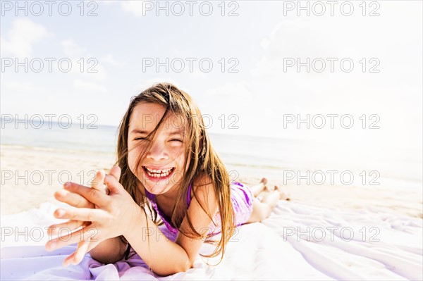 Portrait of happy girl (6-7) sunbathing